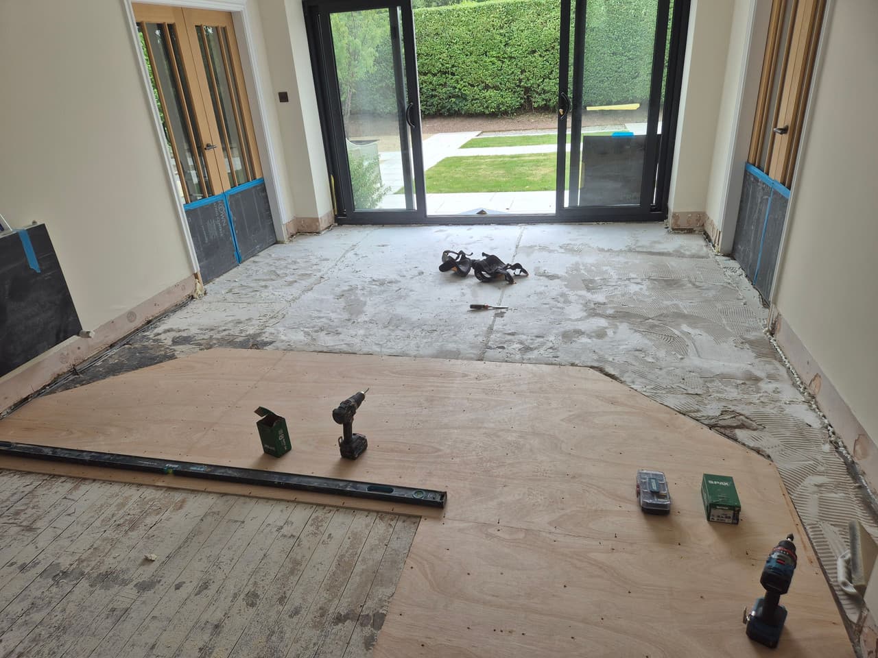 New plywood overboarding being fixed down over the timber floor to create a stable rigid base